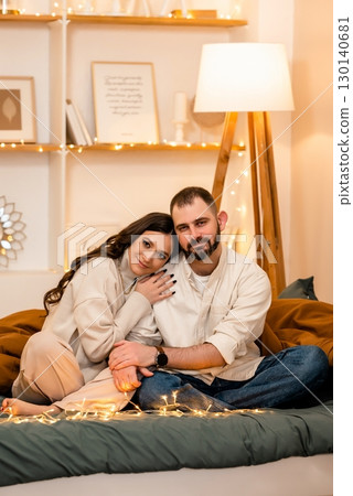 Cozy Couple Relaxing in Warmly Lit Living Room Cozy Couple Relaxing in Warmly Lit Living Room 130140681