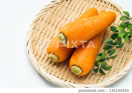 Fresh carrots arranged in a colander 130140910