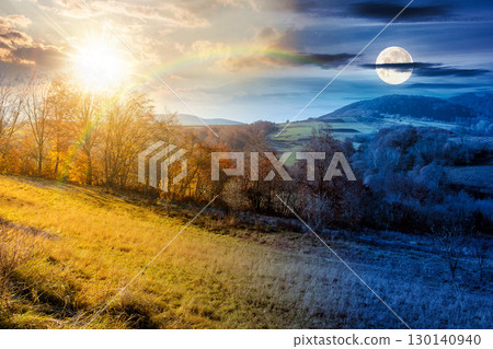 rural landscape on autumn equinox. day and night time change concept. trees on rolling hills. scenic view of mountainous countryside in fall season with sun and moon at twilight 130140940