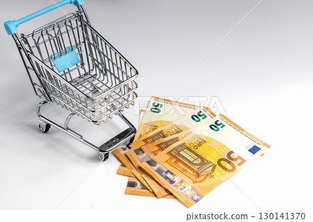 Money and shopping cart on white 130141370