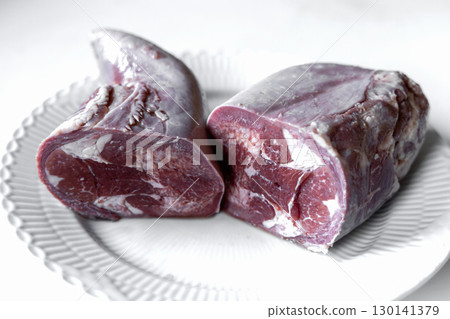 Boiled beef tongue on white serving plate 130141379