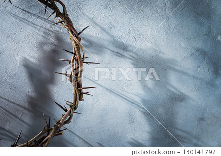 Jesus Crown of thorns casting a distinct shadow for Christian background, Easter concept creating a symbolic image of suffering, sacrifice, and space Copy remembrance for text 130141792