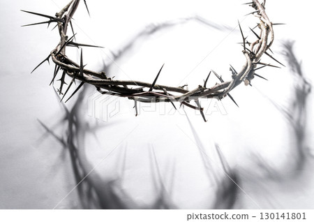 Crown of thorns casting a distinct shadow a white background, creating a symbolic easter image of suffering, sacrifice, and remembrance Copy good for text space friday Crown of thorns casting a distinct shadow a white background, creating a symbolic easter image of suffering, sacrifice, and remembrance Copy good for text space friday 130141801