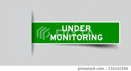 Green color square label sticker with word under monitoring that inserted in gray background 130142399