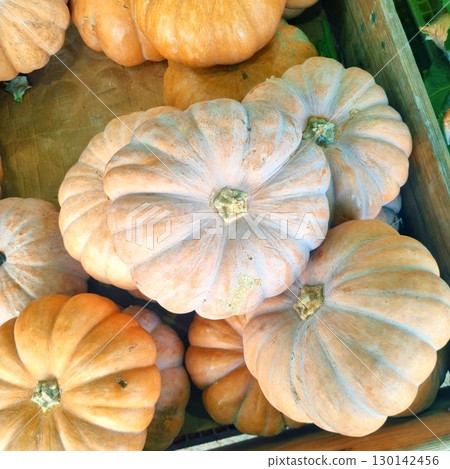 The images show a pile of ripe Korean pumpkins, also known as 'neulgeun hobak,' which are commonly used for soups and porridges. The images show a pile of ripe Korean pumpkins, also known as 'neulgeun hobak,' which are commonly used for soups and porridges. 130142456