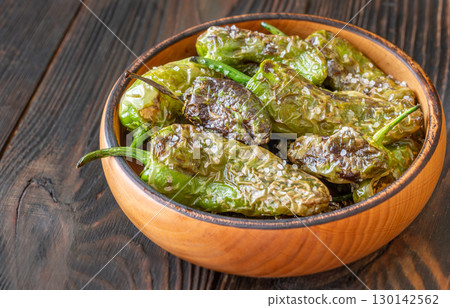 Terracotta bowl of Pimientos de Padron sprinkled with coarse sea salt Terracotta bowl of Pimientos de Padron sprinkled with coarse sea salt 130142562