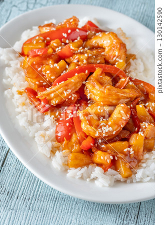 Sweet sour prawns with pineapple bell peppers onions served with rice Sweet sour prawns with pineapple bell peppers onions served with rice 130142590