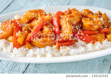 Sweet sour prawns with pineapple bell peppers onions served with rice Sweet sour prawns with pineapple bell peppers onions served with rice 130142591