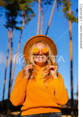 Woman faceless yellow sweater closing eyes with orange dahlia into camera Autumn Fall Bouquet for Thanksgiving holiday. Seasonal Warm colorful blossom flowers arrangement festive decoration Woman faceless yellow sweater closing eyes with orange dahlia into camera Autumn Fall Bouquet for Thanksgiving holiday. Seasonal Warm colorful blossom flowers arrangement festive decoration 130142621