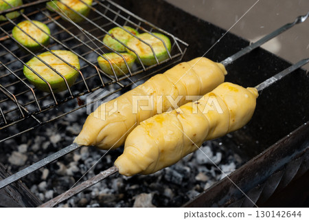 Chopped zucchini and khachapuri roasting on fire seasoned with aroma herbs and spices. Delicious fresh vegetables vegetarian grilling on barbecue smoker grid. Diet vegan bbq. Outdoor recreation Chopped zucchini and khachapuri roasting on fire seasoned with aroma herbs and spices. Delicious fresh vegetables vegetarian grilling on barbecue smoker grid. Diet vegan bbq. Outdoor recreation 130142644