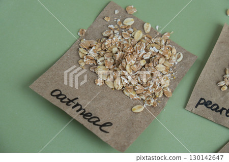 Raw oatmeal porridge with text in paper. Refill product format eco-friendly living. Filling reusable container Whole spelt grain species. High protein fiber-rich vegan plant based food ingredient 130142647