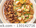 Fried potatoes chanterelle mushrooms seasoned paprika rustic wooden table plate 130142716