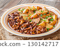 Fried potatoes chanterelle mushrooms seasoned paprika rustic wooden table plate 130142717