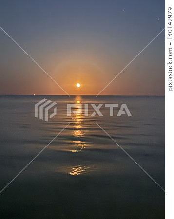 Moon Reflection Over Calm Ocean at Night. 130142979