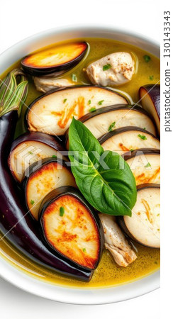 Flavorful chicken and eggplant dish served in aromatic broth with fresh herbs and spices for a delightful dining experience 130143343