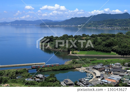 Omura Line train running along Omura Bay in summer 130143627