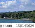 Omura Line train running along Omura Bay in summer 130143629