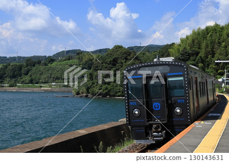 Omura Line train running along Omura Bay in summer 130143631