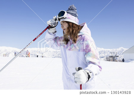 Cute woman enjoying snowboarding 130143928