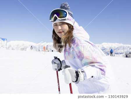 Cute woman enjoying snowboarding 130143929