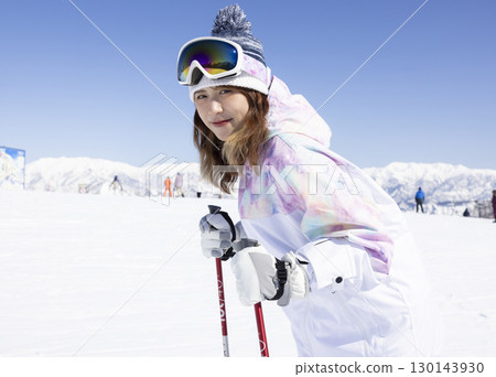 Cute woman enjoying snowboarding 130143930