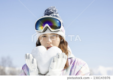 Cute woman enjoying the snowy mountains 130143976