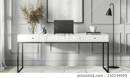 A serene workspace featuring a sleek desk, modern laptop, and stylish decor 130144099