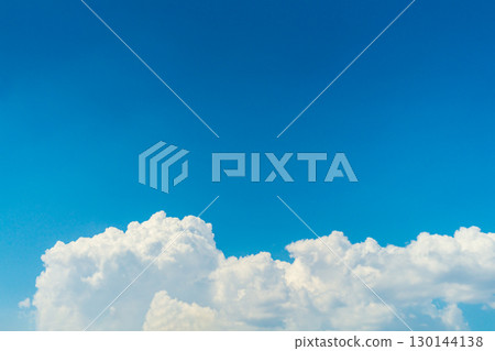 Natural cumulus fluffy white clouds on the background of a blue clear sky with an empty copy space. Blank template for text, advertise, artwork. Nature atmosphere environment on sunny day 130144138