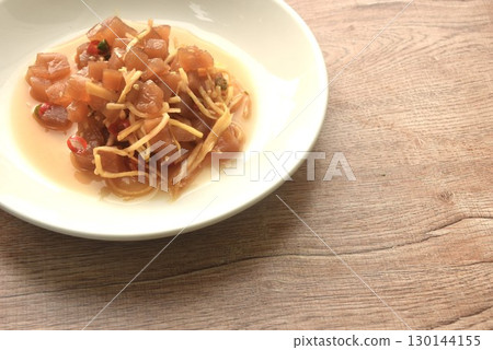 slick pickled rasidh with ginger and chili Chinese salad on plate 130144155