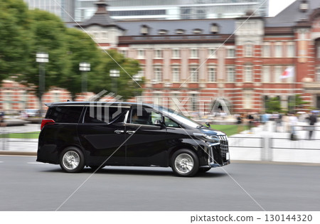 A black car passing in front of Tokyo Station A black car passing in front of Tokyo Station 130144320