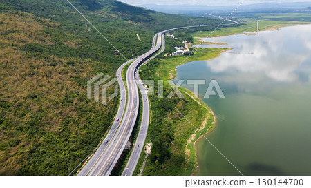 Drone shot The M6 motorway Nakhon Ratchasima Province - Bang Pa-in Lam Ta Khong River and Mountain. Motorway Korat Thailand Drone shot The M6 motorway Nakhon Ratchasima Province - Bang Pa-in Lam Ta Khong River and Mountain. Motorway Korat Thailand 130144700