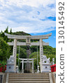 The shrine's torii gate and approach stairs stand out against the blue sky 130145492