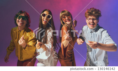 Happy retro disco group dancing with energy in studio lights Happy retro disco group dancing with energy in studio lights 130146142