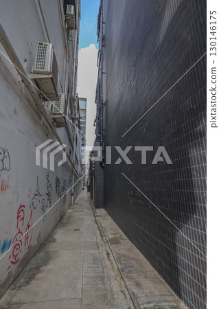 Aug 23 2025 Narrow Alleyway Between Urban Buildings Featuring Graffiti 130146175