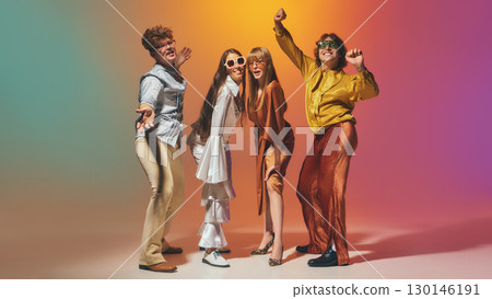 Smiling retro-styled friends in 70s inspired fashion enjoying dance performance 130146191