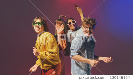 Retro styled friends posing together in vintage disco fashion Retro styled friends posing together in vintage disco fashion 130146194