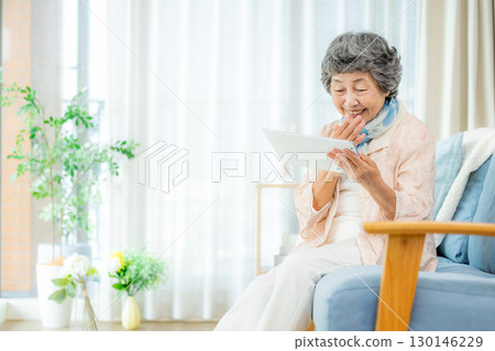 Senior women using tablet devices 130146229