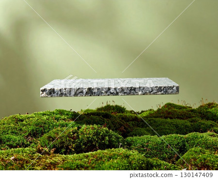 Square Stone Floating Above Green Moss with a Soft Gradient Background 130147409