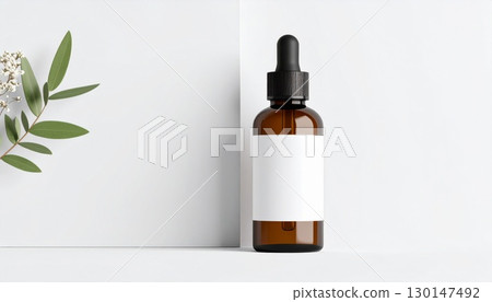 Amber Bottle with Blank Label Featuring Cosmetic Serum and Minimalist Plant Decor Amber Bottle with Blank Label Featuring Cosmetic Serum and Minimalist Plant Decor 130147492