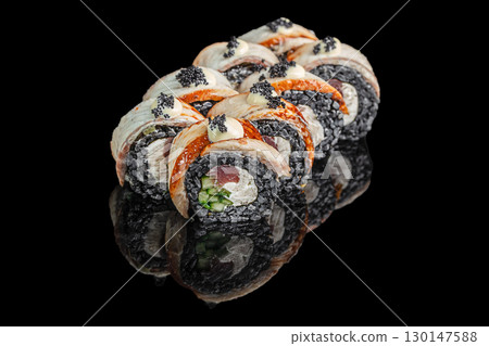 Black sushi rolls with fish, cucumber, and caviar on black background Black sushi rolls with fish, cucumber, and caviar on black background 130147588