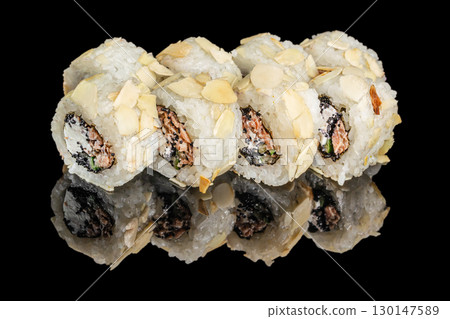 Sushi rolls with almonds, fish, and caviar on black background 130147589