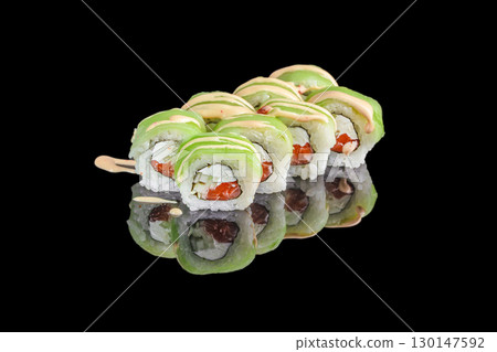 Avocado sushi rolls with salmon and cream cheese topped with sauce on black background 130147592