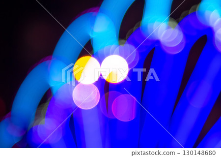 Out-of-focus golden and colorful light circles on a dark base 130148680