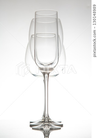 A sleek lineup of three elegant, empty wine glasses with long stems A sleek lineup of three elegant, empty wine glasses with long stems 130148989