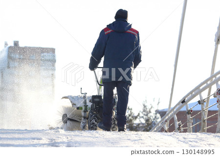 man cleaning the street from snow manual tractor special man cleaning the street from snow manual tractor special 130148995