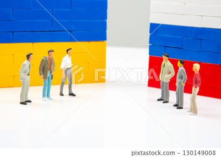 Conceptual photo featuring small human figures separated by blocks Conceptual photo featuring small human figures separated by blocks 130149008