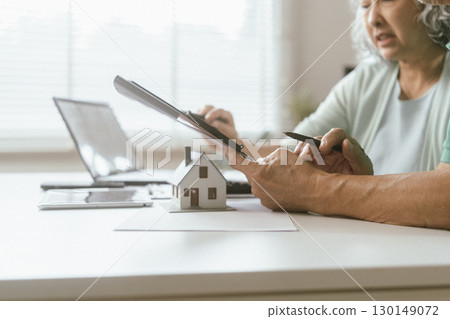 senior couple and documents with laptop for finance, budget planning or retirement annuity on sofa. Elderly man, woman or house with smile, computer or paperwork for pension fund or insurance senior couple and documents with laptop for finance, budget planning or retirement annuity on sofa. Elderly man, woman or house with smile, computer or paperwork for pension fund or insurance 130149072