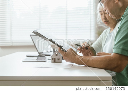 senior couple and documents with laptop for finance, budget planning or retirement annuity on sofa. Elderly man, woman or house with smile, computer or paperwork for pension fund or insurance senior couple and documents with laptop for finance, budget planning or retirement annuity on sofa. Elderly man, woman or house with smile, computer or paperwork for pension fund or insurance 130149073