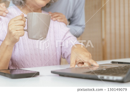 senior couple and documents with laptop for finance, budget planning or retirement annuity on sofa. Elderly man, woman or house with smile, computer or paperwork for pension fund or insurance 130149079