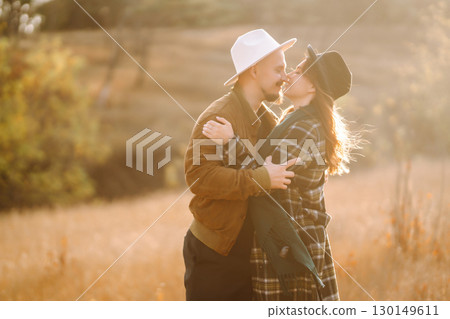 Lovely hipster couple enjoying each other in the autumn park. Nice autumn day. love and lifestyle. Lovely hipster couple enjoying each other in the autumn park. Nice autumn day. love and lifestyle. 130149611